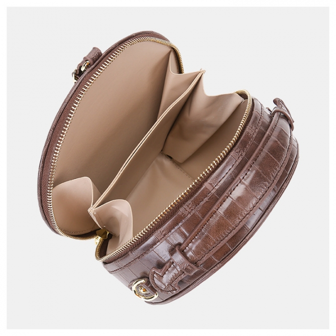 runde Umhängetasche aus Alligatorleder im modernen Stil mit Gepäckanhänger 